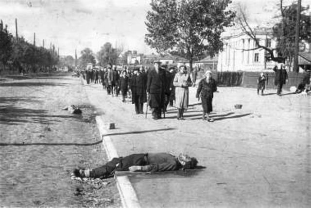 Babi-Yar Corpses on the sidewalk. Location is  the right side of Pobeda Avenue